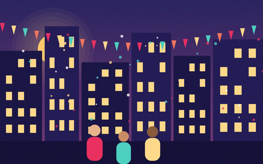 Neighbors setting up folding tables and string lights along a closed residential street for a block party.